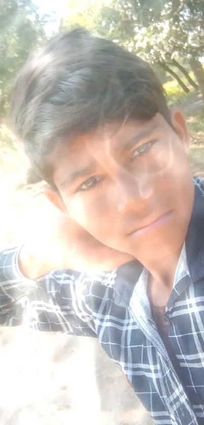 Young person on sunny path with trees and nature in the background.