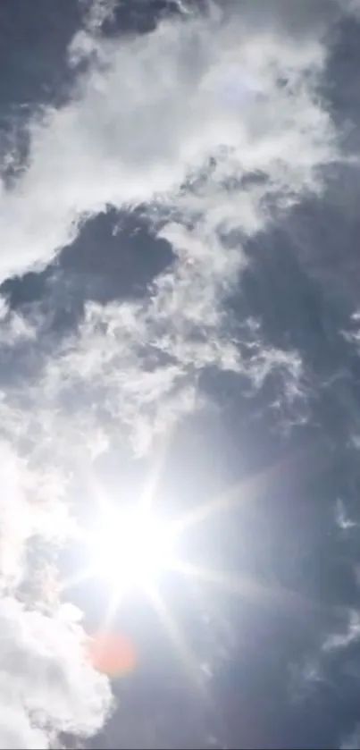 Sunny sky with white clouds and radiant sun overhead.