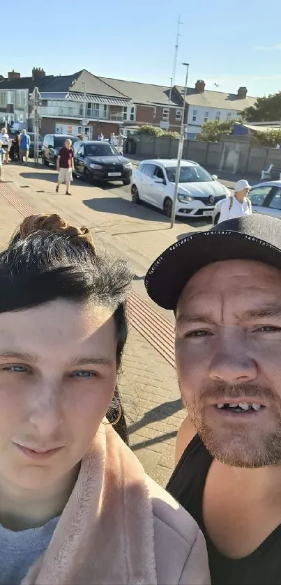 Urban couple strolling under a sunny blue sky.