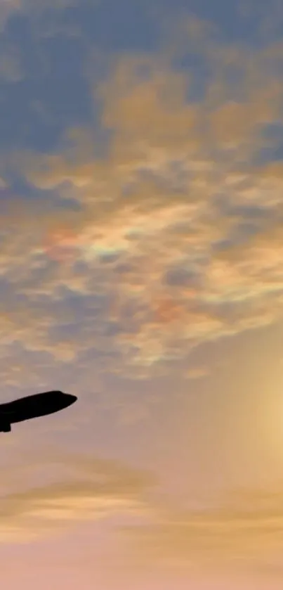 Airplane silhouette against a vibrant sunset sky with clouds.