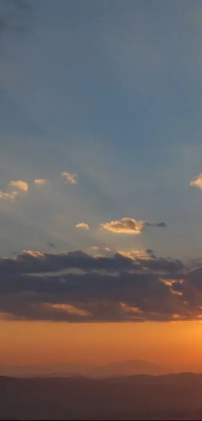 A captivating sunset with vibrant sky and clouds in warm orange hues.