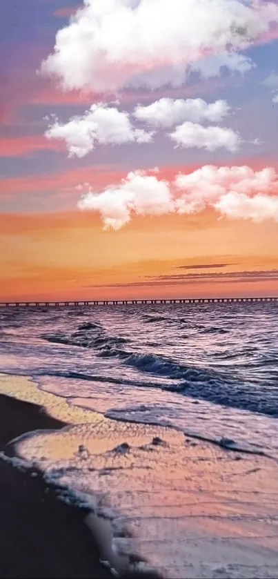 A vibrant sunset beach with clouds over the ocean and a sandy shore.