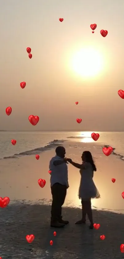 Romantic sunset beach dance with floating heart balloons.