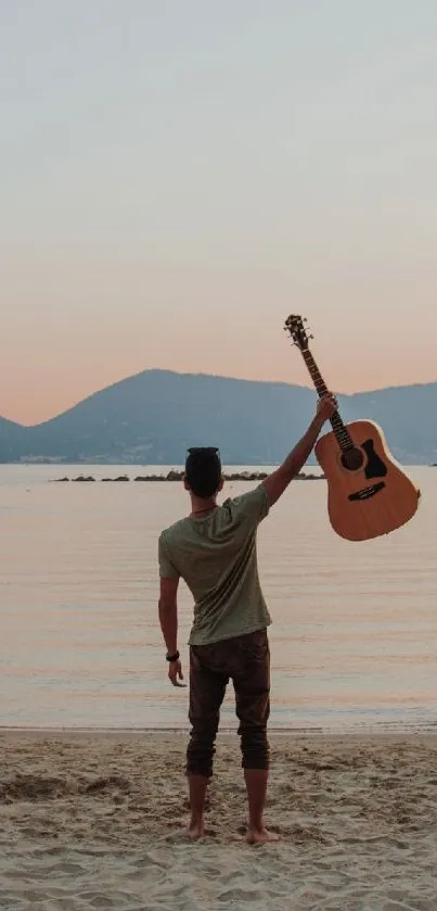 Man with a guitar at sunset beach, tranquil scene.