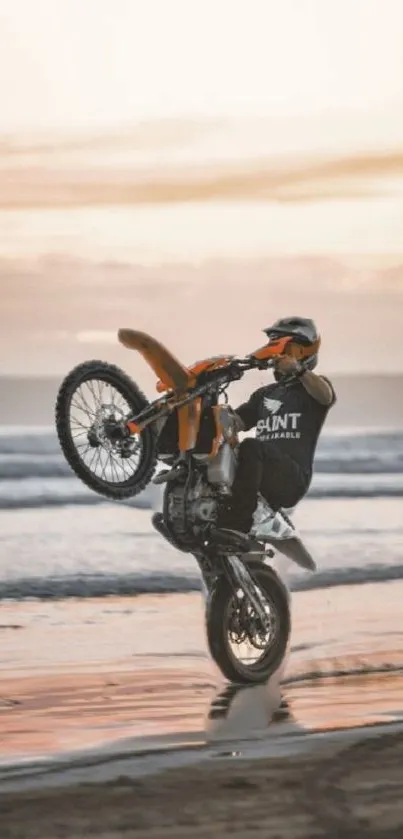 Motorcycle performs a sunset stunt on the beach.