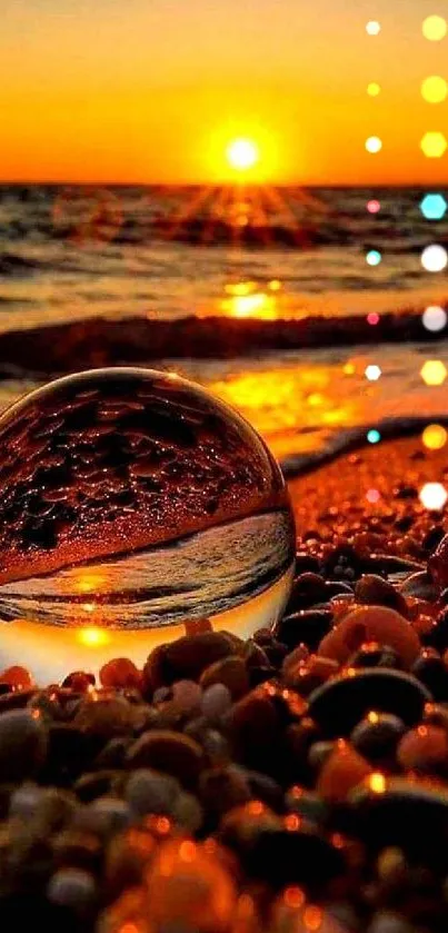 Crystal ball reflecting a stunning sunset over a pebble-covered beach.