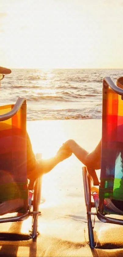 Couple relaxing on chairs at beach during sunset.