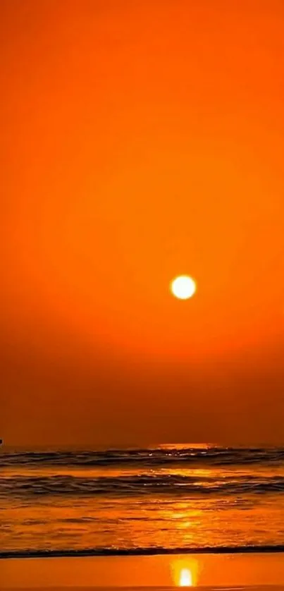 Silhouetted figure at sunset on beach with orange sky.