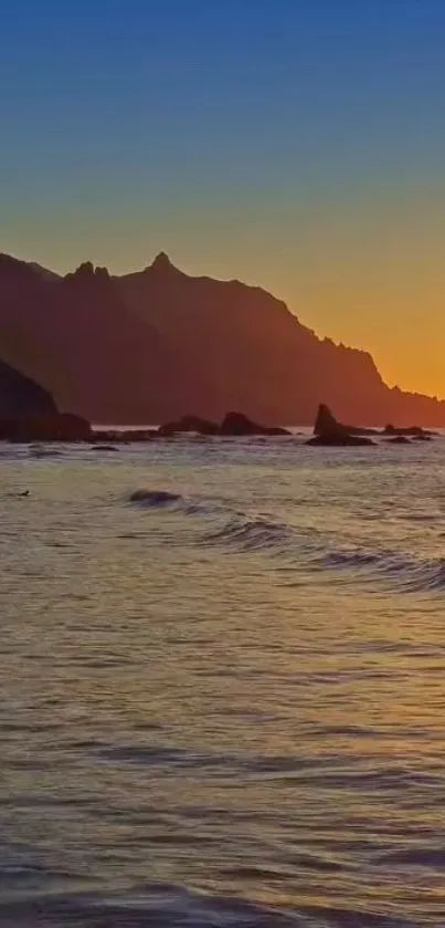 Beautiful sunset beach with golden ocean waves and distant mountains.