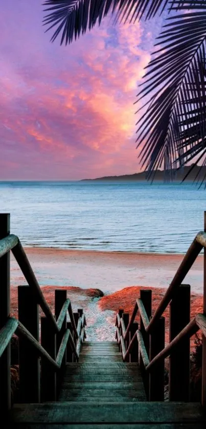 Stunning sunset view from a wooden stairway leading to a tropical beach.