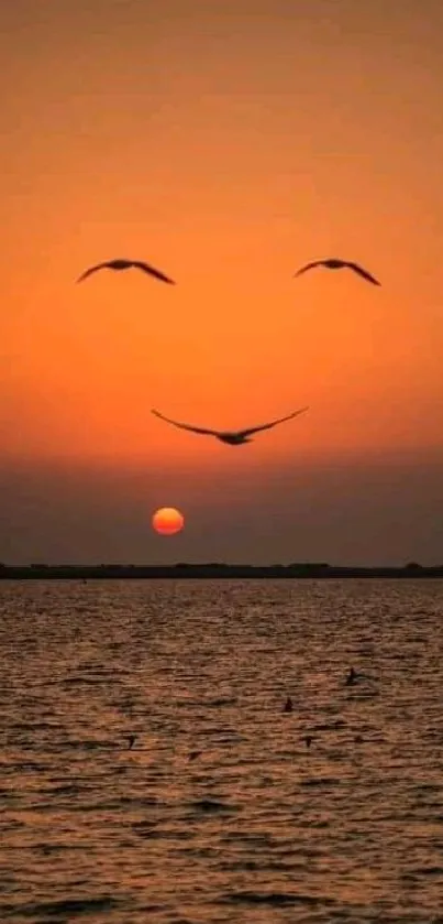 Serene sunset with flying birds over ocean and orange sky.