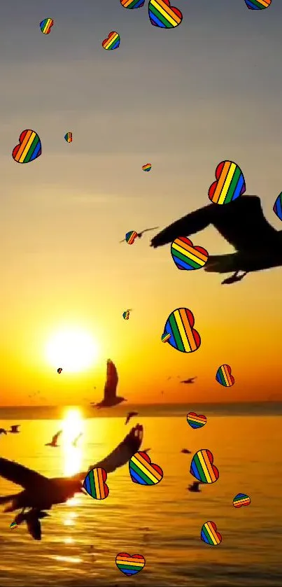 Sunset with birds and rainbow hearts over the ocean horizon.