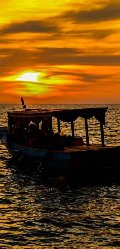 Silhouetted boat against a vibrant sunset sky over the sea.