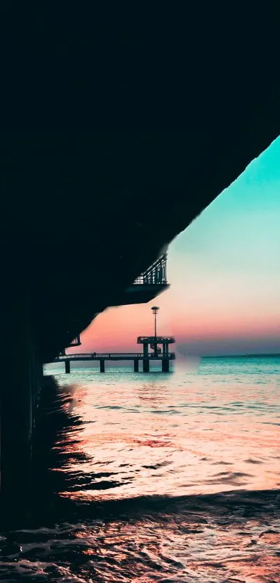 Serene sunset with vibrant sky viewed from a pier, over tranquil ocean waters.