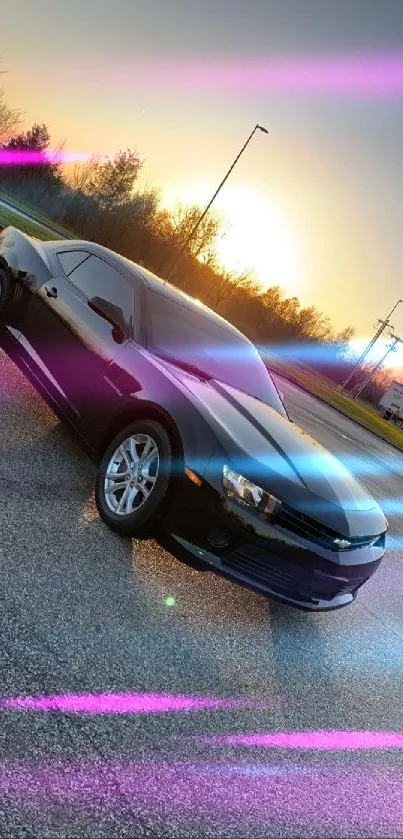 Sleek black car parked on asphalt under sunset sky.