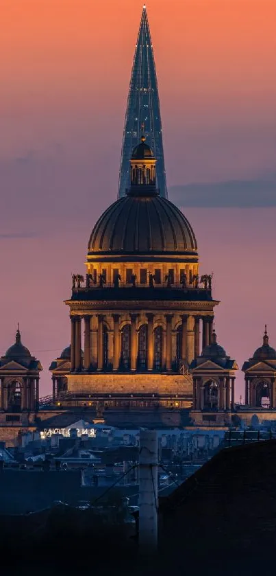 Sunset cityscape with dome silhouette against vibrant sky.