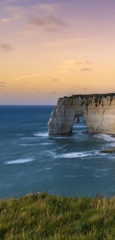 Beautiful sunset over ocean cliffs with pastel skies and tranquil sea.