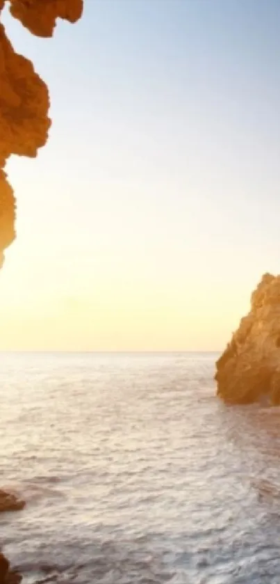 Serene sunset over a coastal landscape with rocky cliffs and ocean waves.