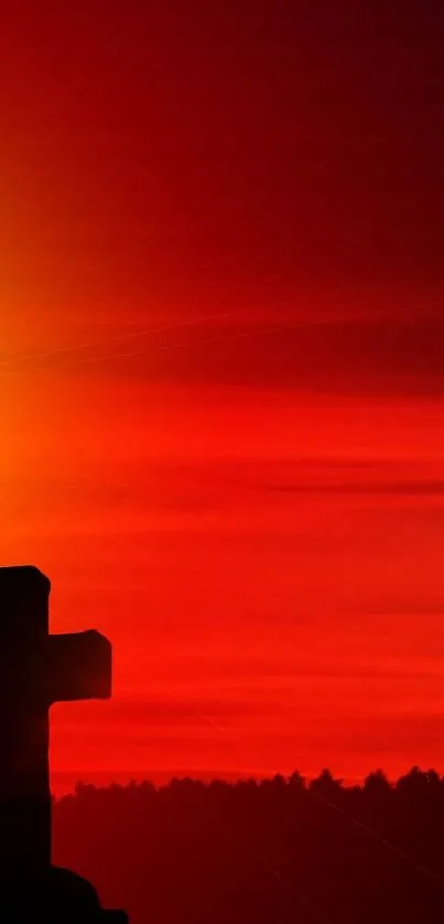 Silhouette of crosses against a red sunset sky.