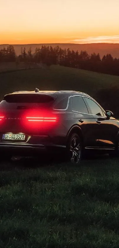 Car at sunset with glowing taillights in a serene landscape.