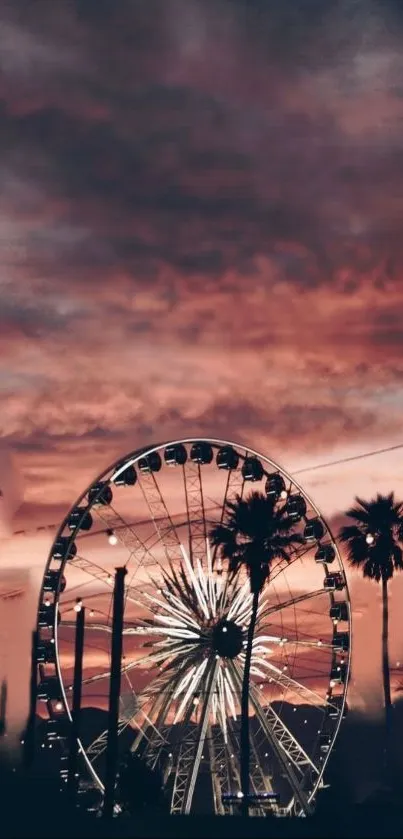 Ferris wheel and palm trees against a crimson sunset sky, creating a scenic view.