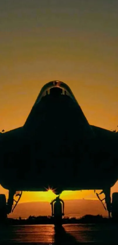 Silhouette of a fighter jet against a vibrant sunset background.