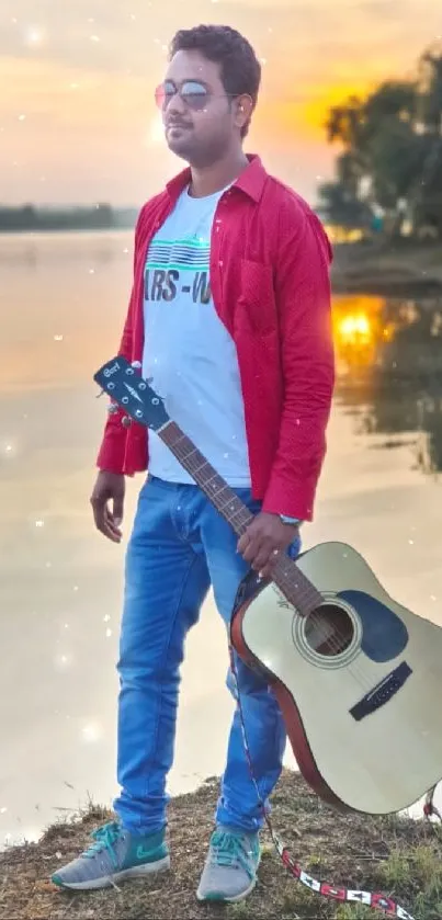 Man with guitar by a lakeside at sunset.