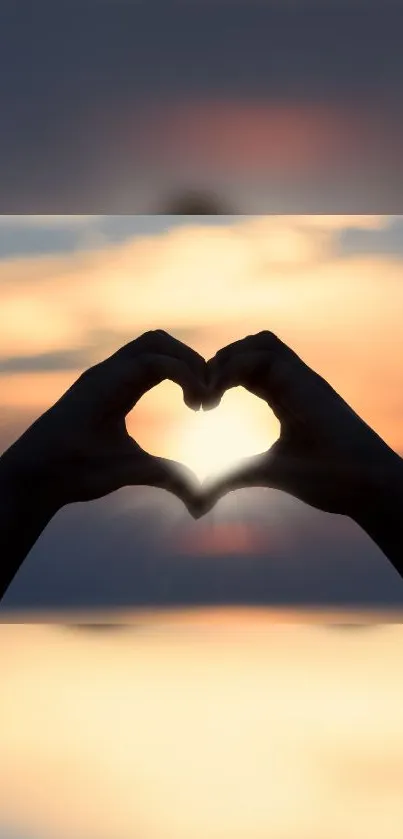 Silhouette of hands forming a heart at sunset, creating a warm, romantic scene.