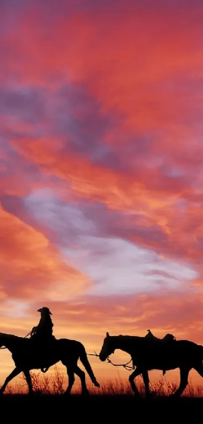 Silhouetted horses against a fiery sunset sky.