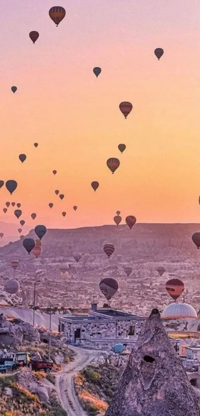 Hot air balloons at sunset over Cappadocia, creating a stunning evening view.