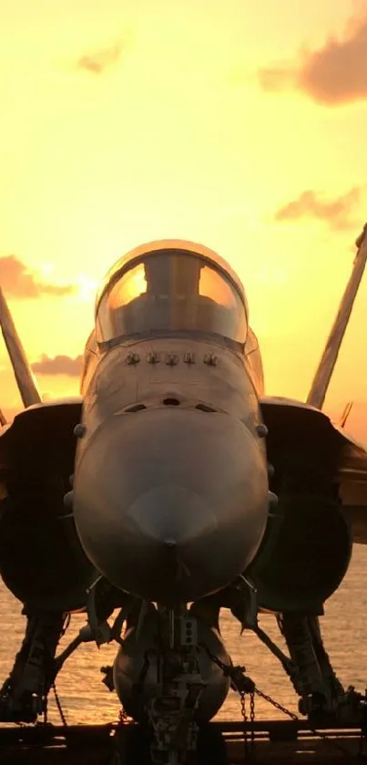 Fighter jet silhouette against a vibrant sunset sky over the ocean.