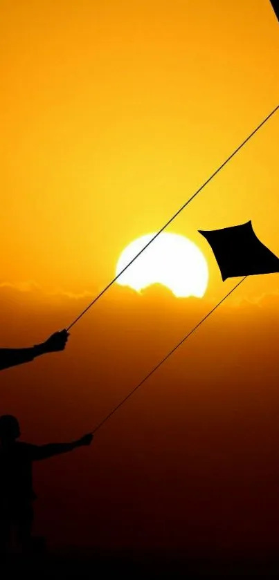 Silhouette of people flying kites at sunset with vibrant orange hues.