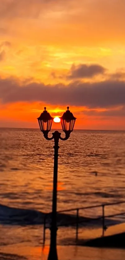 Sunset at the beach with a silhouetted lamppost.