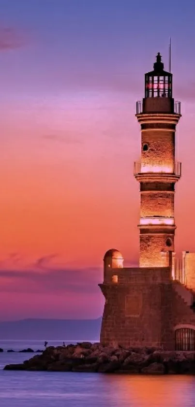 Lighthouse with a vibrant sunset sky reflected on the sea.