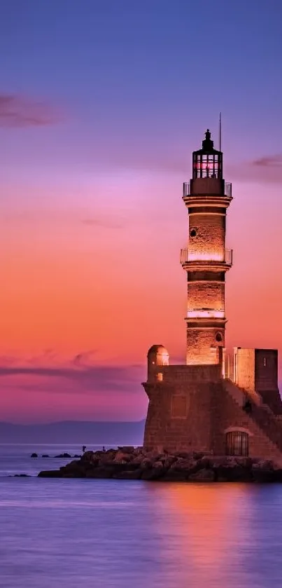 Lighthouse silhouetted against a vibrant sunset sky, with calm ocean waters.