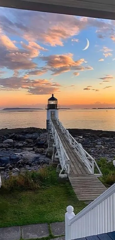 Lighthouse overlooking the ocean at sunset with vibrant sky and calm waters.