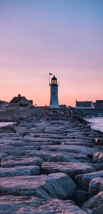 Serene lighthouse and sunset view with calm ocean in the foreground.