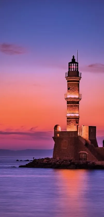 Lighthouse silhouette at sunset over calm ocean.