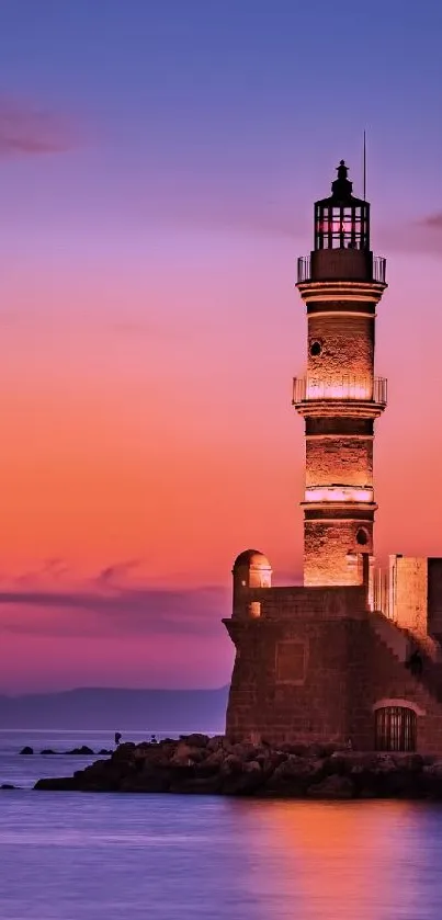 Lighthouse at sunset with orange and purple sky over calm ocean.