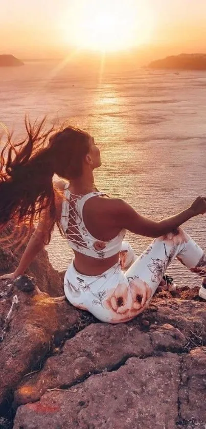 Woman meditating at sunset by the sea, capturing a serene and calming landscape.