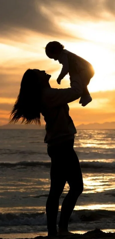 Mother and child silhouette at sunset beach, warm orange tones.