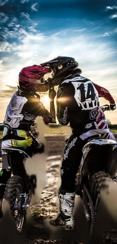 Motocross riders at sunset on dirt bikes.