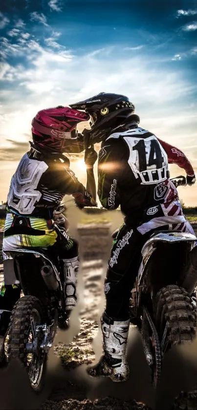 Motocross riders at sunset with helmets and gear, capturing a thrilling adventure.