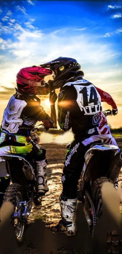 Motocross riders in action at sunset with vibrant sky colors.