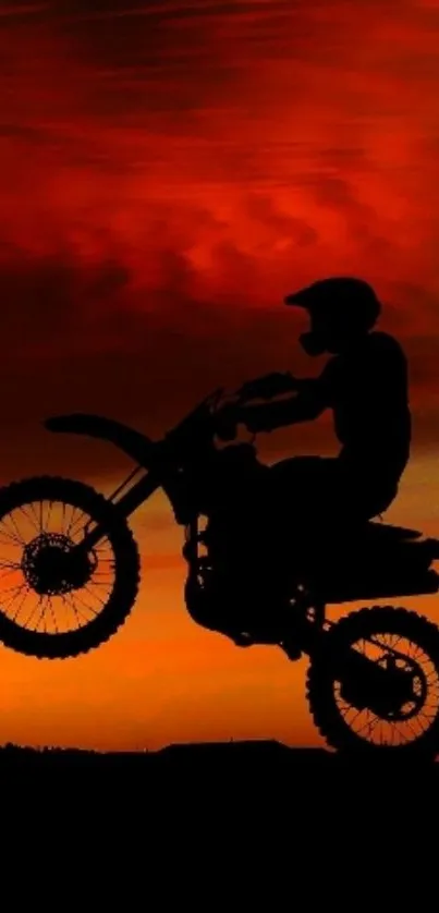 Motocross rider silhouette at sunset.