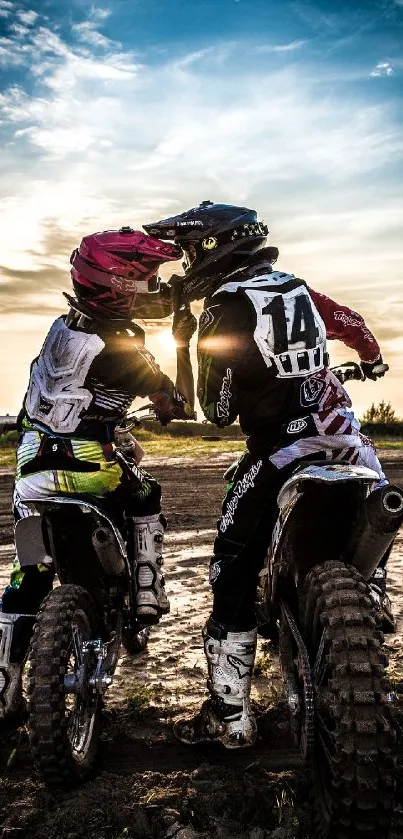 Motocross riders at sunset on a dirt track, capturing an adventurous moment.