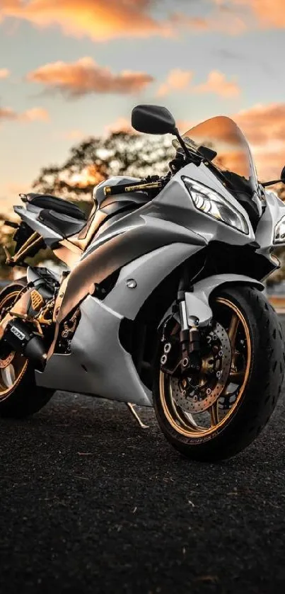 A sleek silver motorcycle at sunset.