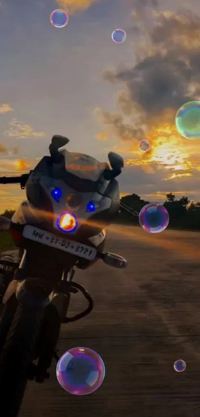 Motorcycle on road at sunset with clouds and vibrant sky.