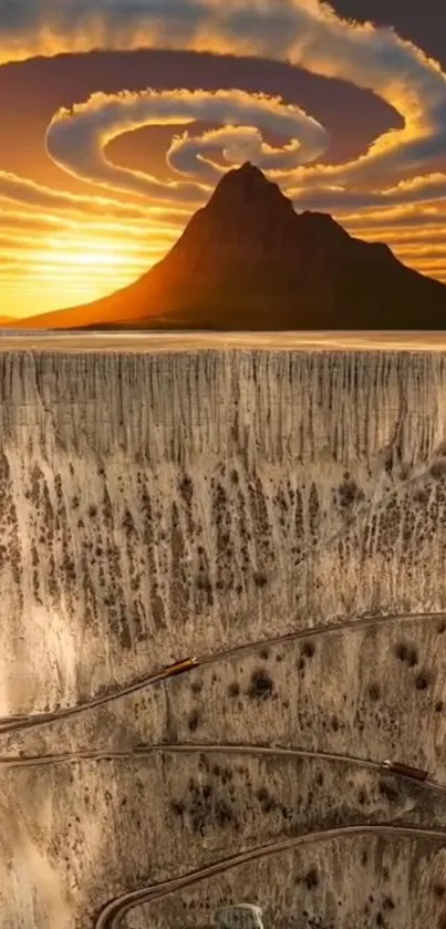 Sunset over mountain with winding road through canyon.