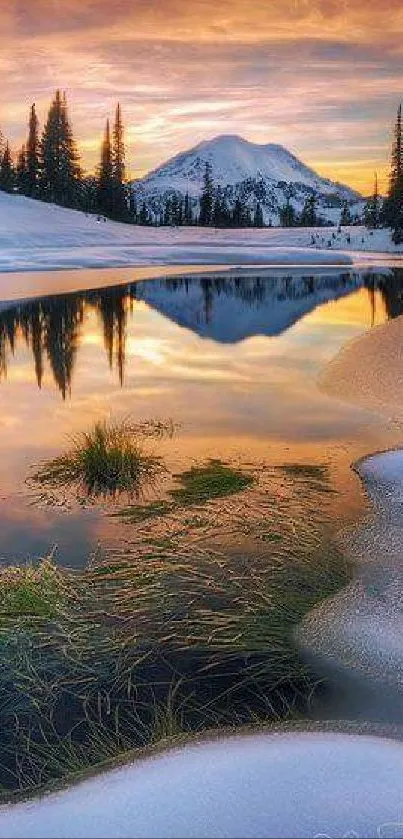 Snowy mountain reflecting in serene lake at sunset, creating a colorful landscape.